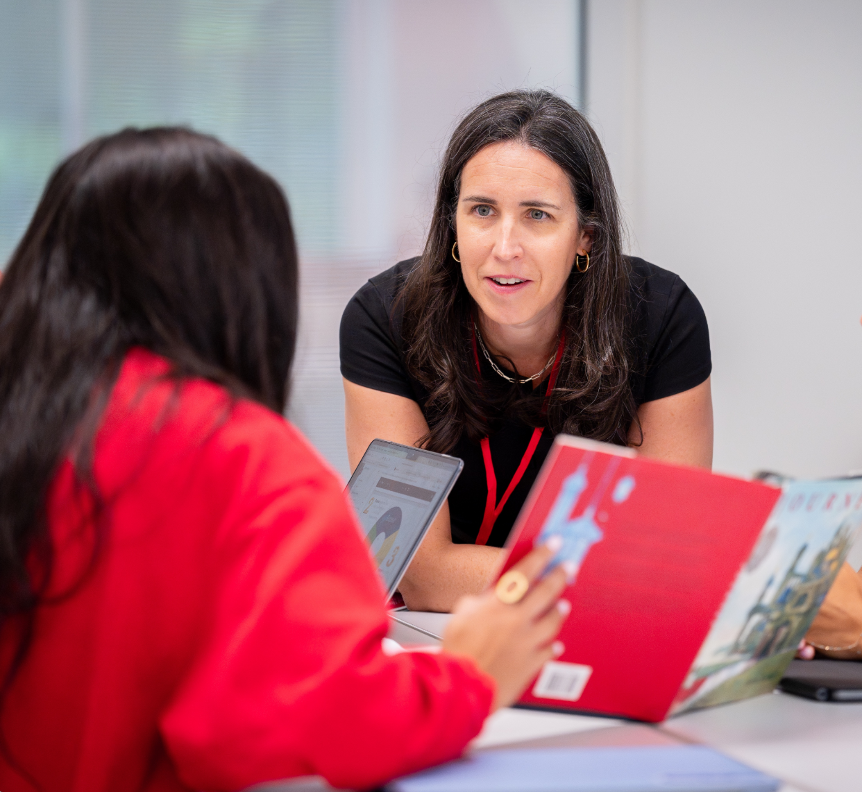 Katie working with a teacher around a picture book